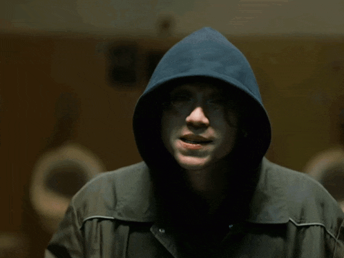 a man wearing a hooded jacket that says boston harley davidson on it