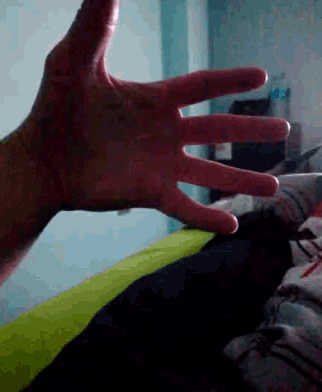 a close up of a person 's hand reaching for something