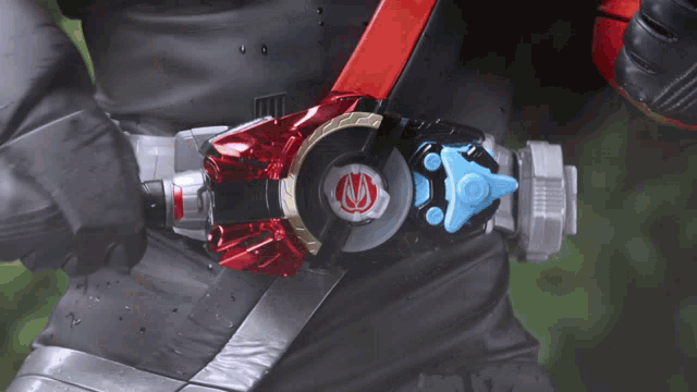 a person is wearing a belt with a red circle on it