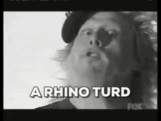 a black and white photo of a man with the words a rhino turd