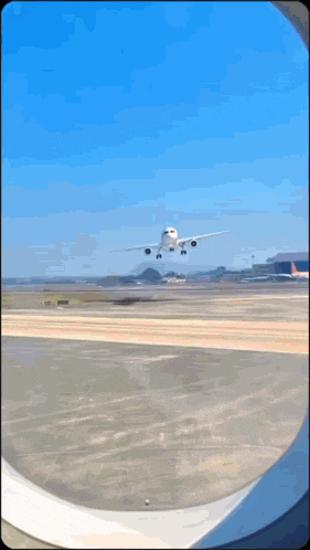 an airplane is taking off from a runway and looking out the window