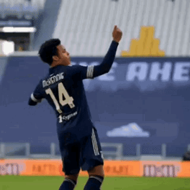 a soccer player with the number 14 on the back of his shirt