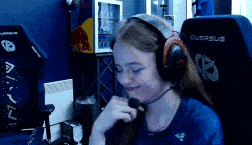 a woman wearing headphones and a quersus chair