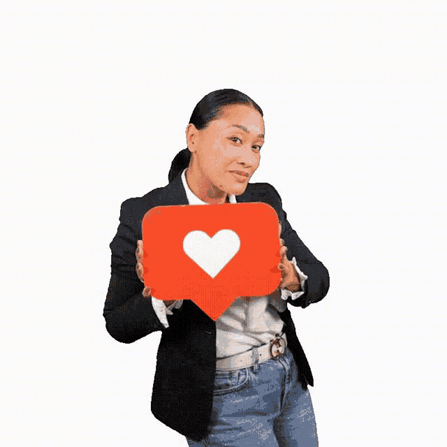 a woman is holding a red heart shaped icon