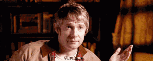 a man in a brown jacket and plaid shirt is saying `` shoot me '' while making a funny face .