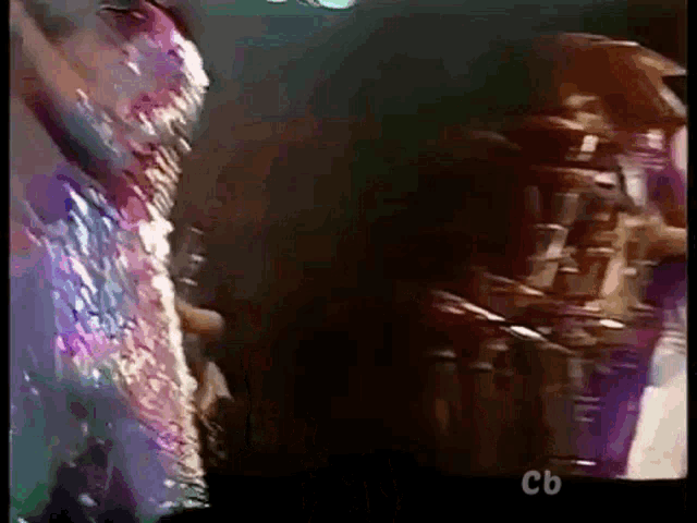 a close up of a person 's face with the letters cb on the bottom right