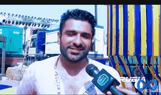 a man holding a microphone that says fully media