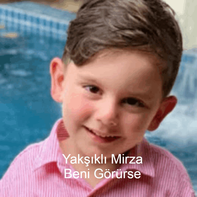 a young boy wearing a pink striped shirt is smiling with a caption that says " yaksikli mirza beni goruse "