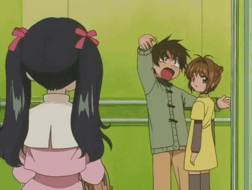a girl with pigtails is standing next to a man and a girl in an elevator .