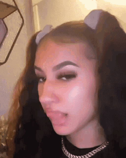 a close up of a woman 's face with her tongue out .