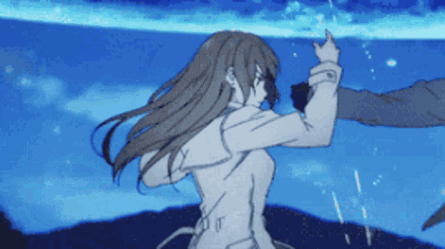 a girl with long brown hair is standing in front of a blue background