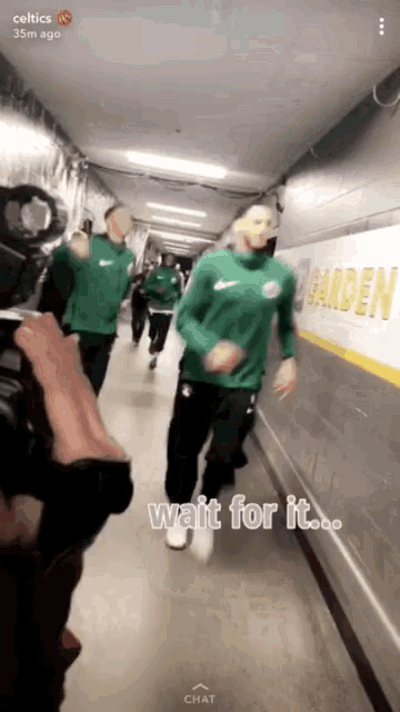 a snapchat of a group of celtics players running down a hallway