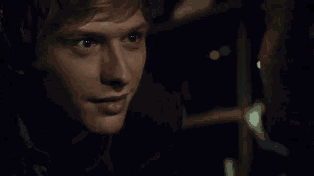a close up of a man looking at another man