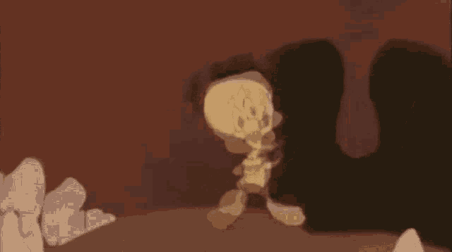 a cartoon character is walking through a cave while holding a sword .