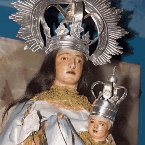 a statue of a woman wearing a crown and holding a baby
