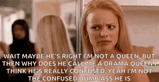 a woman is looking at herself in a mirror while a man is standing behind her .