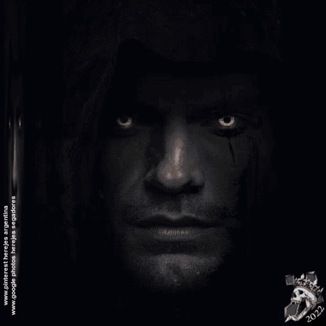a close up of a man 's face with glowing yellow eyes