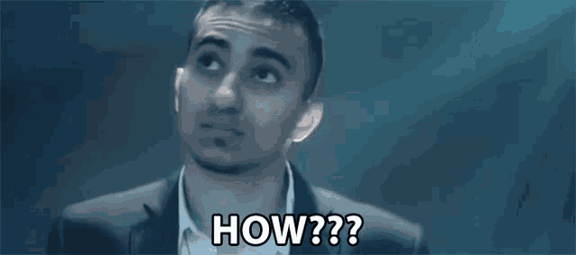 a man in a suit and white shirt is saying how ?