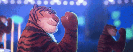 a cartoon tiger is standing on a stage with its paws up .