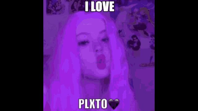 a girl with purple hair is wearing a purple wig and making a funny face .