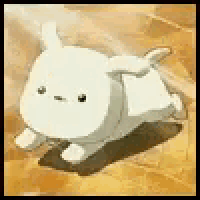 a white sheep is laying down on the ground .