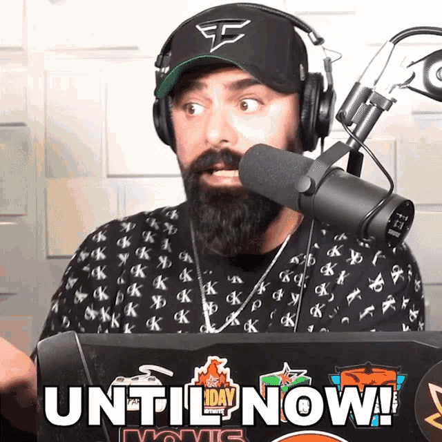 a man with a beard is wearing headphones and a hat that says e on it