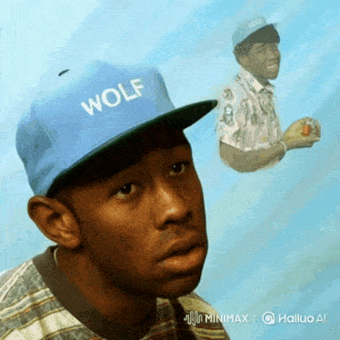 a man wearing a blue hat with wolf written on it