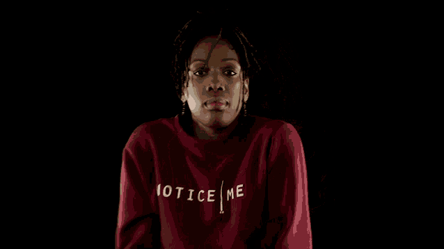 a woman wearing a red sweater that says not me on it