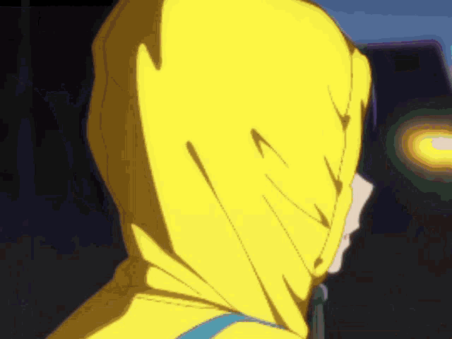 a person wearing a yellow jacket with a hood on