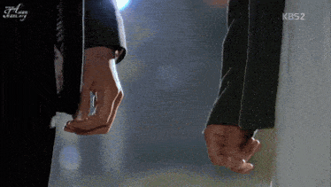 a man and woman holding hands with the kbs2 logo visible