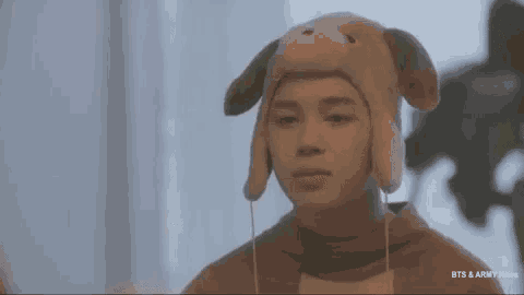a person wearing a dog hat with a heart on their forehead .