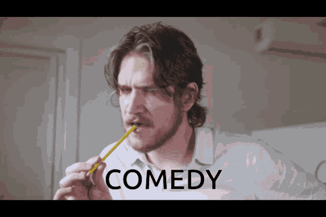 a man brushing his teeth with a pencil and the word comedy behind him