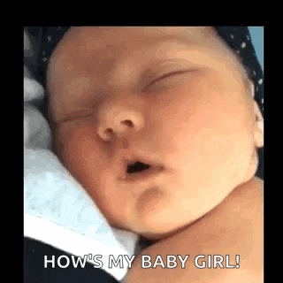 a baby is sleeping with its mouth open and a person is holding it .