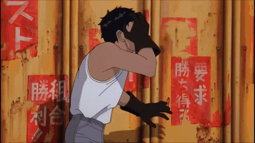 a man covering his face with his hands in front of a wall with chinese writing on it