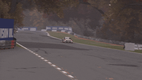 a blurred image of a car driving down a road with a sign that says ' a ' on it