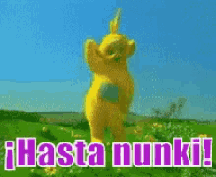 a yellow teddy bear is standing in a field with the words hasta nunki written below it