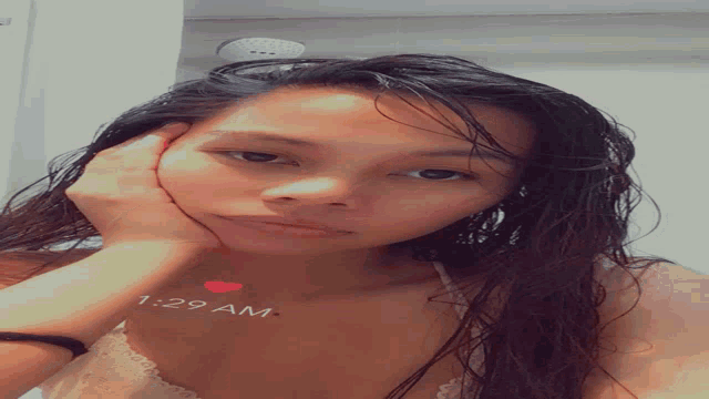 a woman with her head resting on her hand with 1:29 am written on the bottom