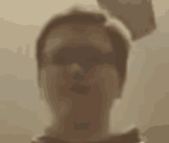 a blurry picture of a man wearing sunglasses .