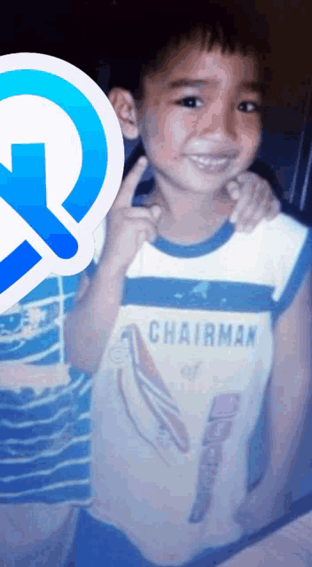 a young boy wearing a shirt that says chairman