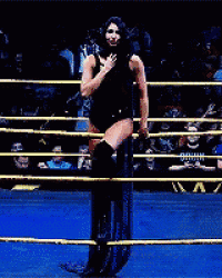 a woman in a black bodysuit is standing in a ring