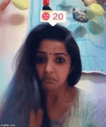 a woman is making a funny face with a sticker that says 20 on her head .
