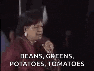 a man is covering his face with his hand and saying `` beans , greens , potatoes , tomatoes ''