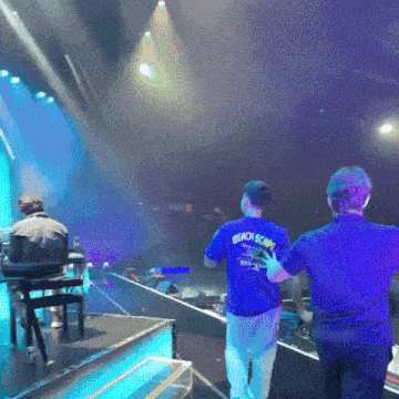 a man wearing a blue shirt that says beach boys