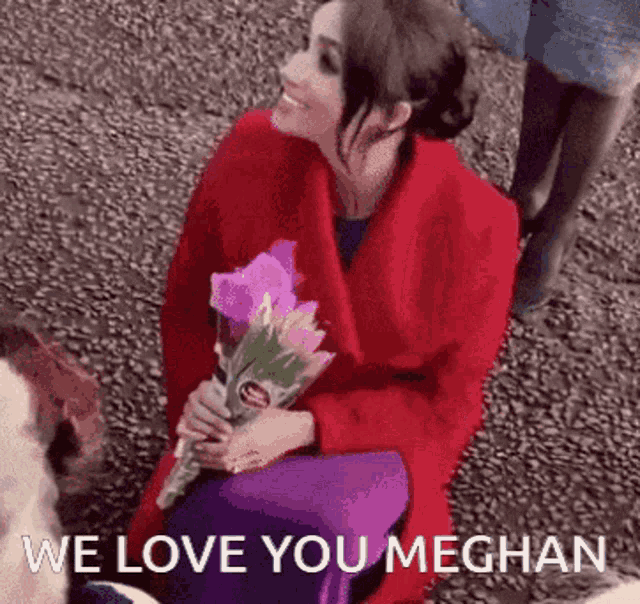 a woman in a red coat is holding a bouquet of purple flowers and says we love you meghan .