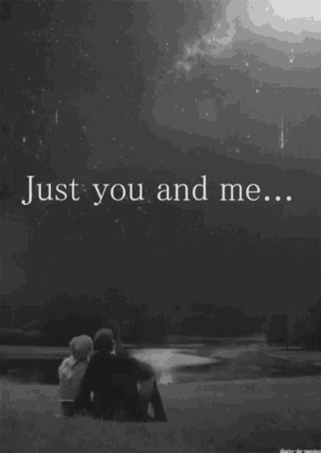 a black and white photo of a couple looking at the stars and the words just you and me