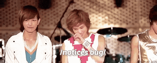 a group of young men are standing next to each other and one of them says notices bug /