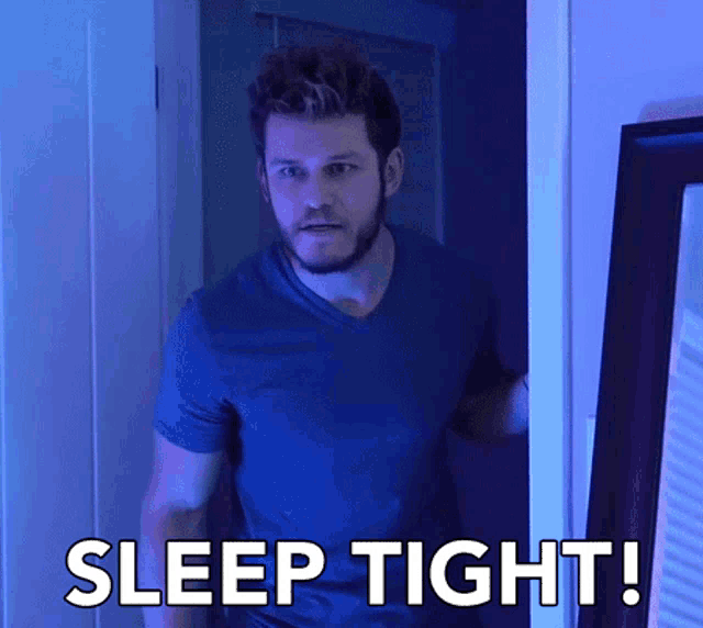 a man in a blue shirt is standing in a doorway with the words sleep tight written on it