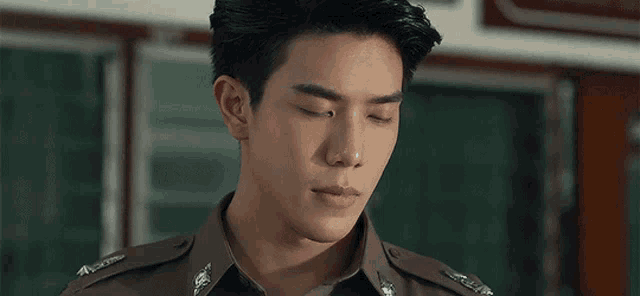 a close up of a man in a police uniform looking at the camera