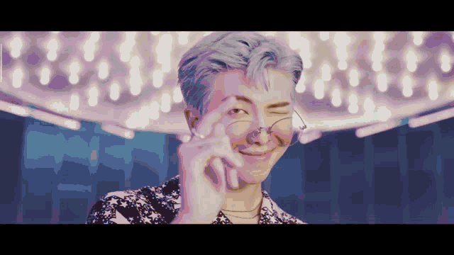 a close up of a person wearing glasses making a funny face