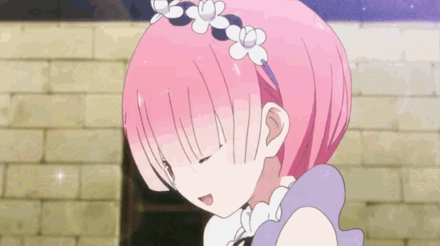 a girl with pink hair is wearing a headband with white flowers .